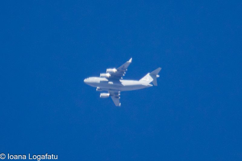 Airplane soaring through a clear blue sky